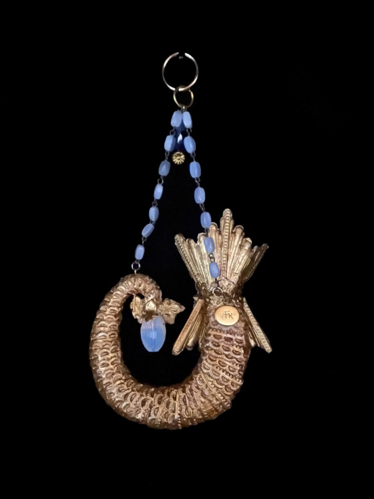 Wife of Poseidon she is adorned with Opalite and ocean blue stones. She is a truly royal merwoman.