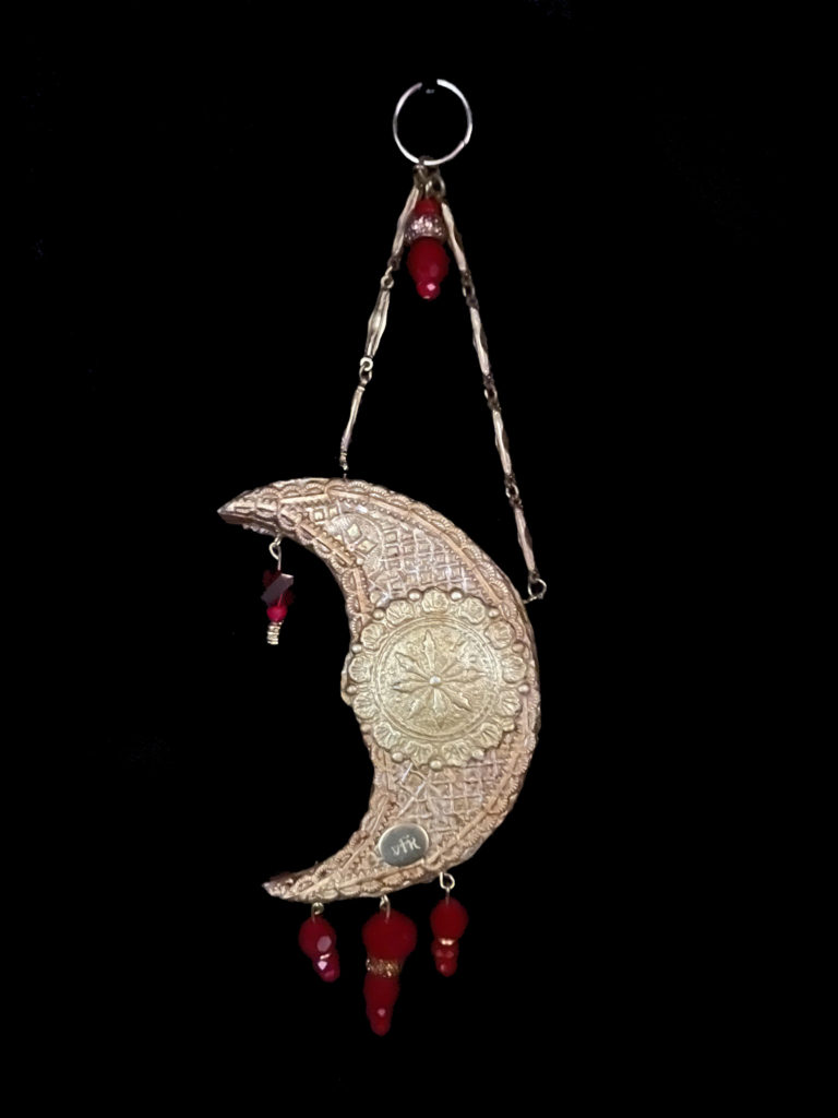 The Blood Moon glows red in the shadow of the sun, its beauty not to be eclipsed. Red velvet beads, glass cabochons, and a glass dome are added enhancements.