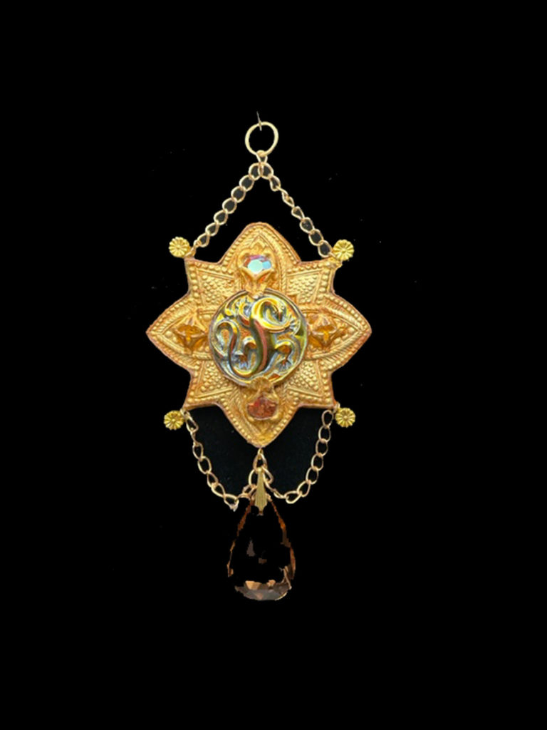 A tiny iridescent dragon is the center of attention on this lovely medallion. A champagne-colored crystal dangles at the bottom of the pendant.