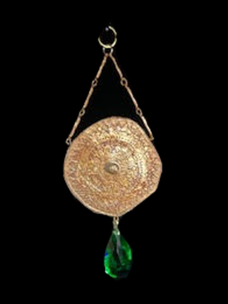 This medallion with a large Emerald green crystal as its center surely will inspire envy of its wearer.