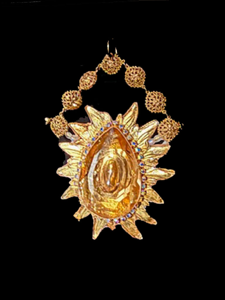 Gold colored pendant with amber crystal