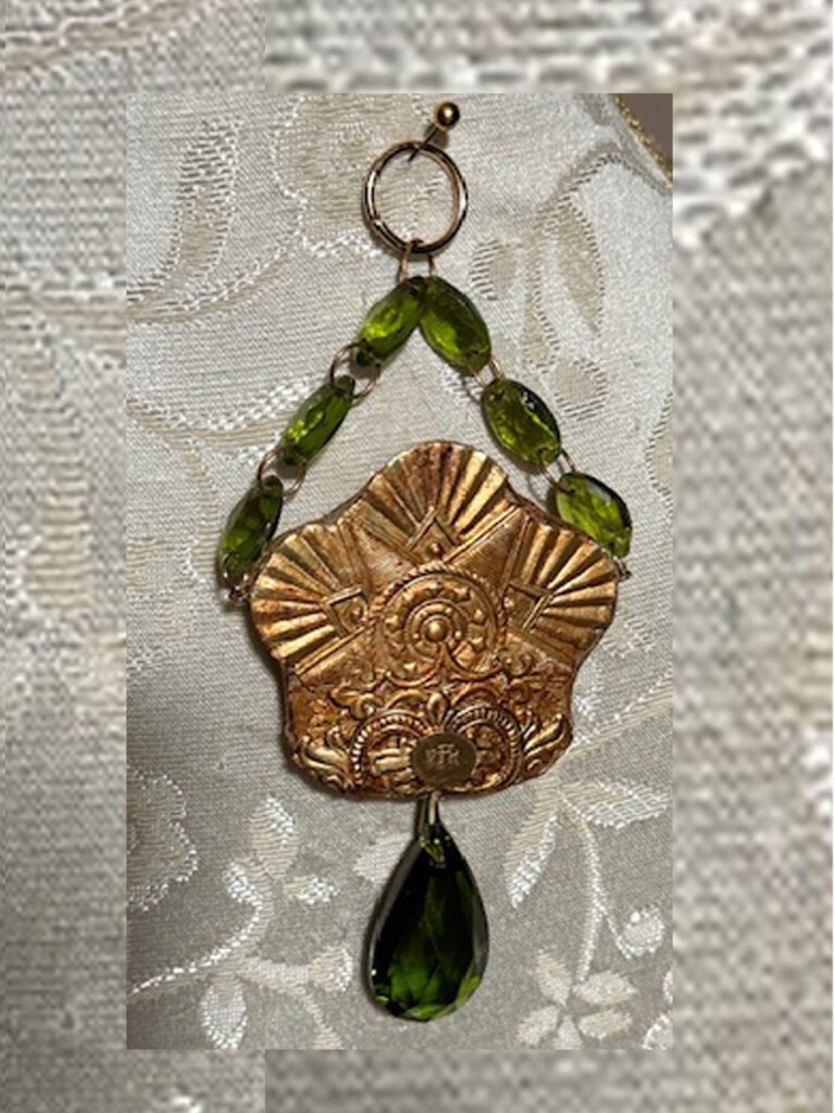Pendant with gold color, face of Father Earth and Green Crystals