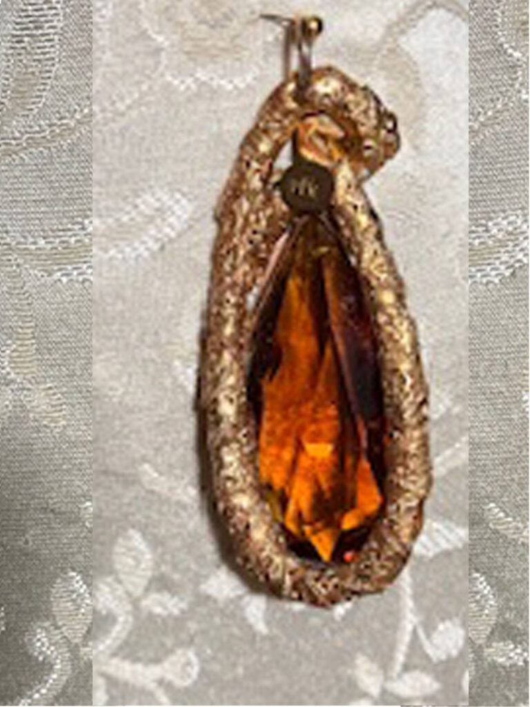 Gold color pendant with honey colored crystal