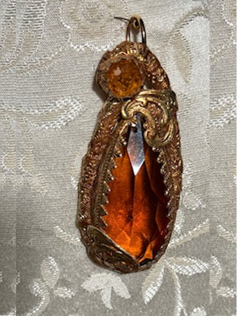 Gold color pendant with honey colored crystal