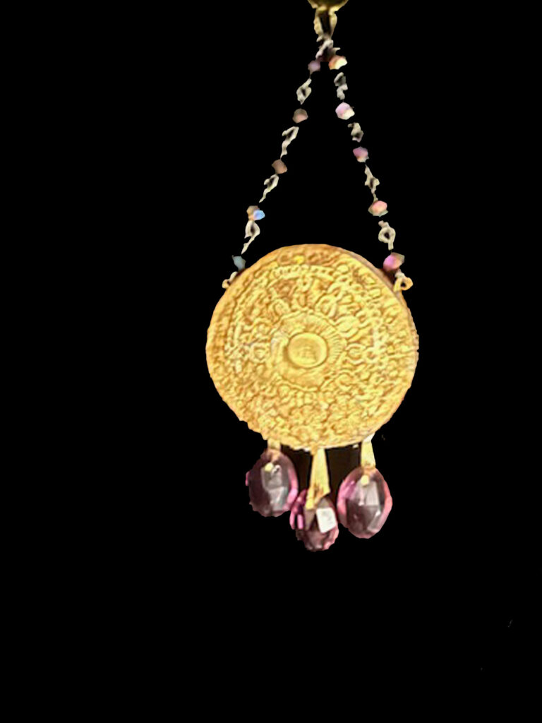 A lavender crystal pendant evokes the sweet scent of Lilacs in the morning sun.