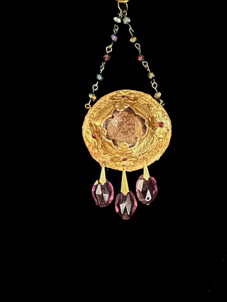 A lavender crystal pendant evokes the sweet scent of Lilacs in the morning sun.